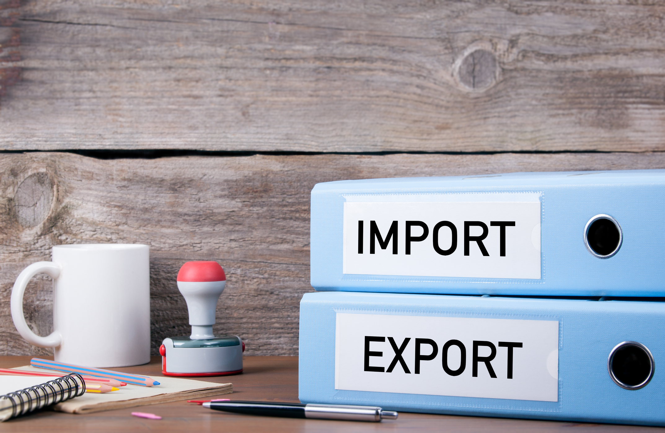 Import and Export binders sitting on a desk in an office.
